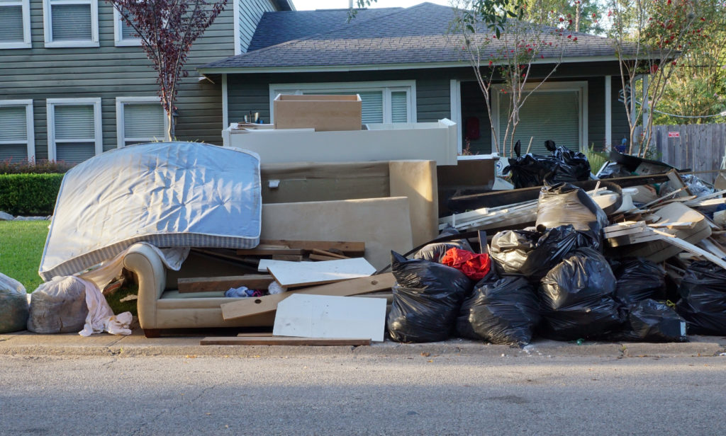 piles of junk in front of home from a cleanout junk removal service