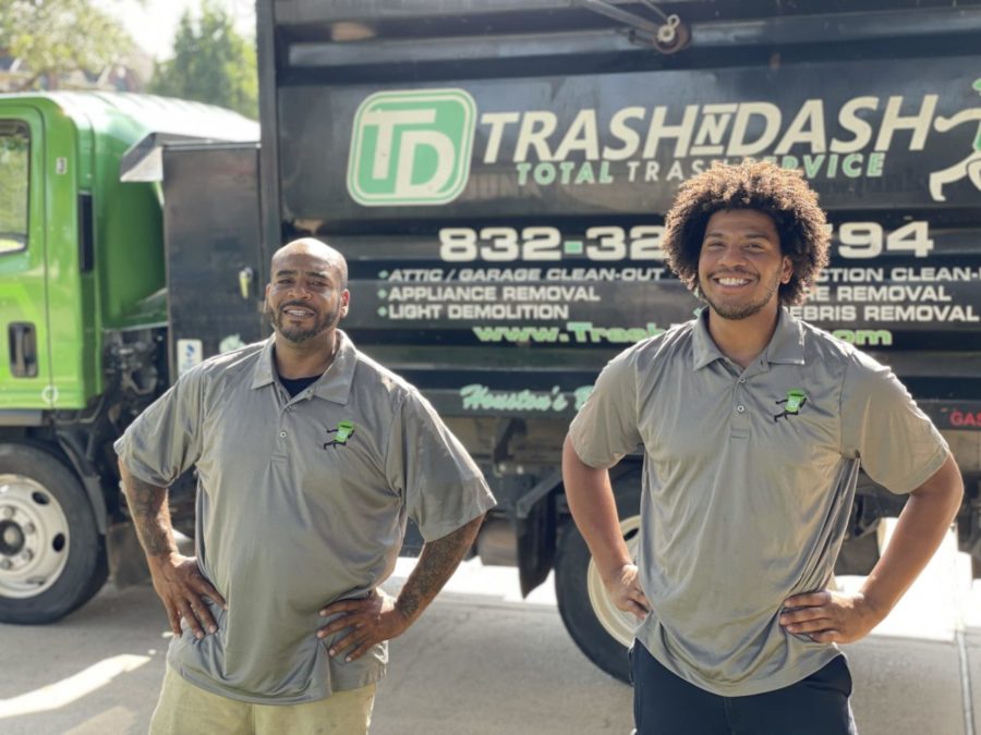 trash n dash junk removal pros smiling in front of junk removal truck